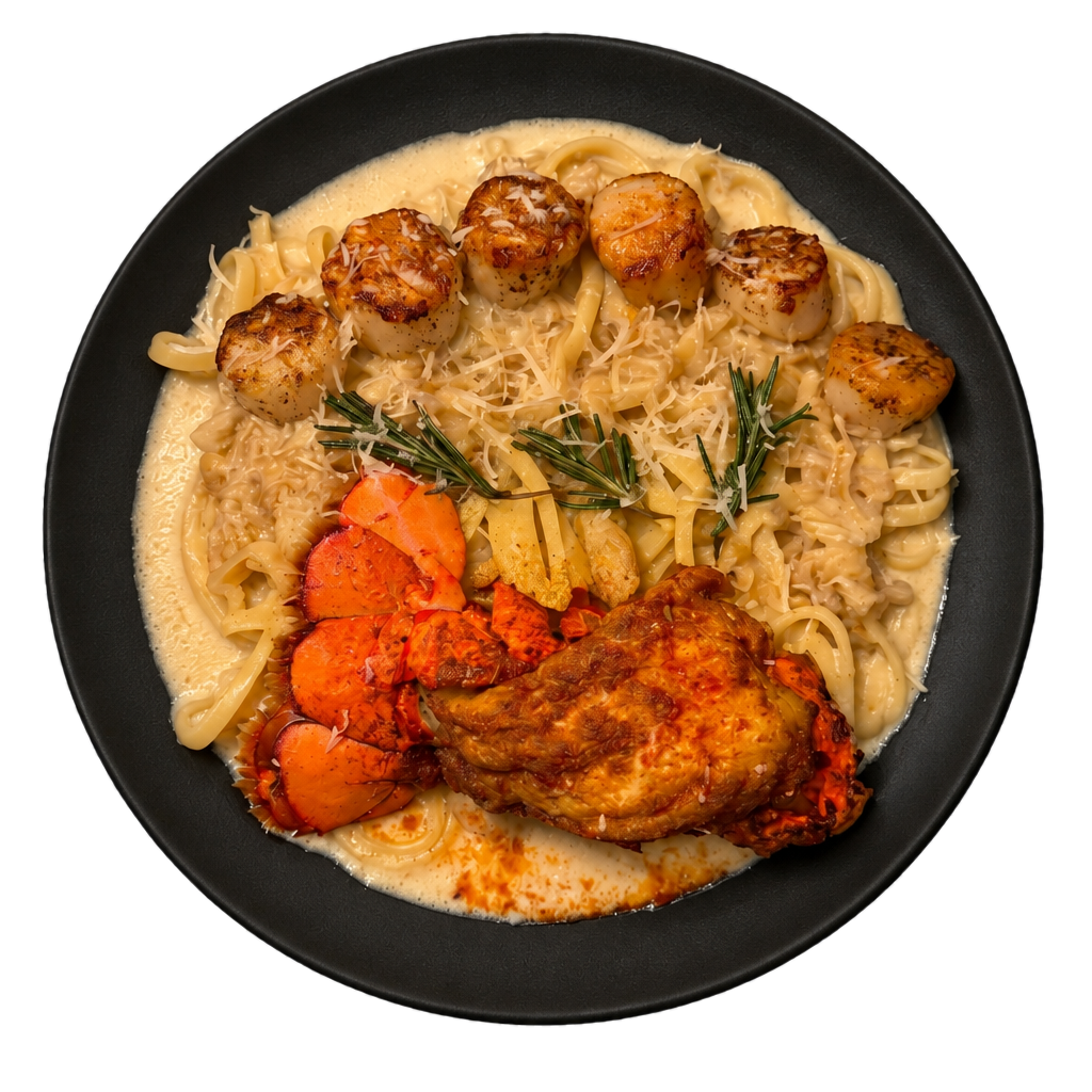 Lobster tail and seared scallops over parmesan cream linguine on a black plate
